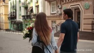 背面正面的情侣在爱一起花时间在城市的街道上散步浪漫的约会视角